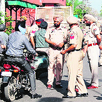 Policemen checking commuters entering the venue of the auction in Amritsar on Friday