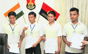 The four divers, who rescued occupants of a jeep that plunged into a GNDTP lake, show the appreciation certificates they received for the brave act, in Bathinda on Friday