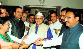 BJP MLAs led by Ramesh Pokhriyal Nishank and Ajay Bhatt present a memorandum against the Bhati panel to Governor Aziz Qureshi in Dehradun on Friday.