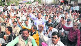 Fourth Class emoployees of the Uttarakhand government sitting on the Haridwar road during a march towards the state Assembly in support of their demands in Dehradun on Friday.