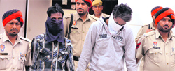 The two snatchers in police custody in Jalandhar on Friday. Photo: Sarabjit Singh
