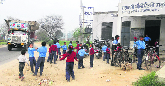 Students of Government Elementary School, Industrial Area, Kapurthala, risk their lives by playing near the busy Kala Sanghian road as the school has no boundary wall. A Tribune photograph