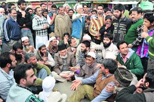 Protesters stage a sit-in against the house arrest of Hurriyat leaders in Srinagar on Friday. 