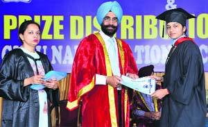 A student receieves a degree from principal Dr Narinder Singh Sidhu during the annual convocation of Guru Nanak National College, Doraha.