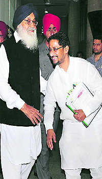Anil Joshi, Industry Minister, bends to touch Chief Minister Parkash Singh Badals feet before entering the Vidhan Sabha in Chandigarh on Friday
