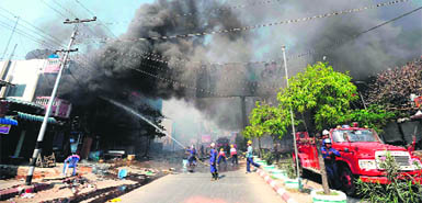 Firefighters in action in riot-hit Meiktila, central Myanmar, on Friday. 