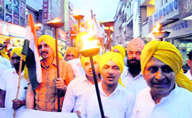 A torchlight procession being taken out in the city to mark the martyrdom day of Bhagat Singh, Rajguru and Sukhdev, on Saturday.