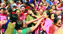 Residents apply eco-friendly colours on each other during the Holi celebrations organised by the UT Environment Department at Government Senior Secondary School, Sector 46, in Chandigarh on Saturday