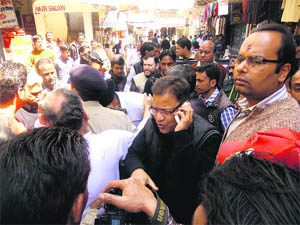 Members of the Mussoorie Traders and Welfare Association block traffic at Green Chowk in Mussoorie on Saturday.