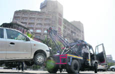 A recovery van tows away a wrongly parked car in Ludhiana on Saturday. 