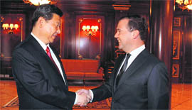 Russia's PM Dmitry Medvedev (R) and Chinese President Xi Jinping during a meeting near Moscow on Saturday.
