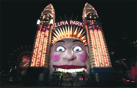 The entrance to the Luna Park in Sydney before and during Earth Hour on Saturday.