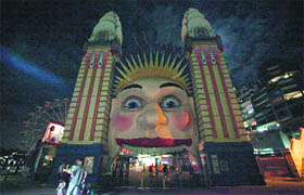 The entrance to the Luna Park in Sydney before and during Earth Hour on Saturday.