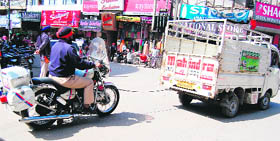 A PCR bike being towed away by an auto-rickshaw on a road in Amritsar on Sunday.