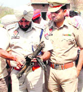DSP Gurmeet Singh Kingra examines the sten gun that was found in an open drain near Sanjay Nagar in Bathinda on Sunday.