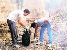 Volunteers of Making A Difference pick garbage in Dehradun on Sunday. 