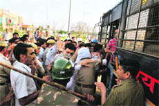 INSO activists being made to board a police vehicle after they showed black flags to Chief Minister Bhupinder Singh Hooda at the Guru Jambheshwar University of Science and Technology, Hisar, on Sunday.