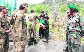 The two Pakistani boys being handed over to the Pakistani army at Chakan da Bagh in Poonch