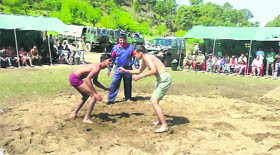 Youths partcipate in a dangal at Jhangar on Sunday.