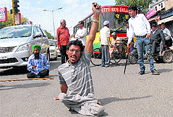 Members of the Handicapped Association, Punjab, block traffic during a dharna in Jalandhar on Sunday. The protesters sought better pension and infrastructure for the disabled