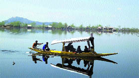 Tourists enjoy a shikara ride on the Dal Lake in Srinagar on Sunday.