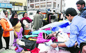 Tourists shop at a market in Srinagar on Sunday.