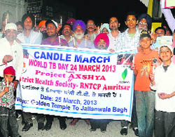 Members of the SGPC take out a candlelight march from the Golden Temple to Jalianwala Bagh in Amritsar on Monday.