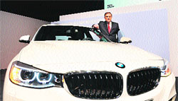 Norbert Reithofer, CEO of the German carmaker BMW, poses with a BMW 3 Series Grand Turismo in Munich, Germany. BMW said on Monday it is cautiously optimistic for business in 2013 after achieving the best year in the company's history last year.  AFP