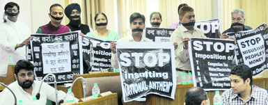 BJP councillors carry banners during a silent protest at the MC House in Chandigarh on Monday. Tribune Photo: Pradeep Tewari