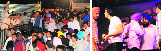 A policman pacifies the audience during the star nite on the Panjab University campus in Chandigarh on Monday. Tribune Photos: S Chandan Punjabi singer Babbu Mann argues with students during the event.