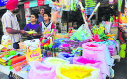 Children buy herbal colours in Chandigarh on Monday. Tribune photo: S Chandan 