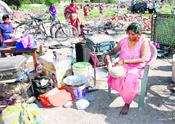 Guddi Devi tends to her amputated leg amid rubble.