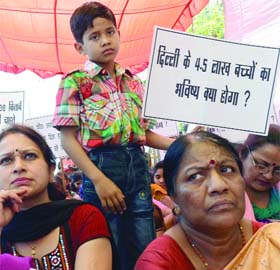 Members of Delhi State Public Schools Management Association staging a dharna near the Delhi Vidhan Sabha on Monday against the closure of their schools in Delhi