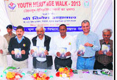 Uttarakhand Sports Minister Dinesh Aggarwal releases a book on heritage of Doon by Lokesh Ohri (second from right) in Dehradun.