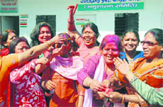Women Congress workers celebrate Holi at the Congress Bhavan in Dehradun on Monday.
