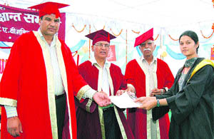A student receives her degree during the convocation function of DAV College for Women, Kosli, recently. 
