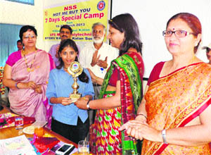 Pankaj Mittal, Vice-Chancellor of BPS Mahila Vishwavidyalaya, Khanpur Kalan, gives away a prize to an NSS volunteer during a programme on the university premises. 