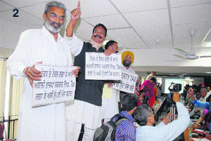 Congress councillors stand on benches to stage protest against property tax