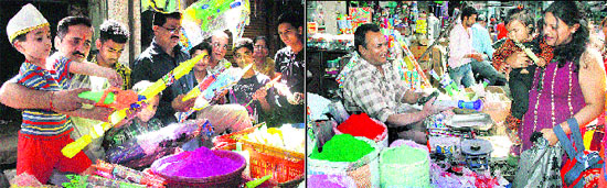 A child checks a water gun for purchasing ahead of Holi; and (right) a woman buys colours and a water gun for her child in Jalandhar on Monday.