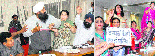(Left) Senior Deputy Mayor Kamaljit Singh Bhatia, Deputy Mayor Arvinder Oberoi and BJP councillor Joginder Singh Tony jostle with each other for a mike; woman councillors of the Congress protest against the imposition of property tax at the Jalandhar MC Budget meeting on Monday. 