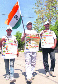 Three youngsters travel on foot through Jalandhar to spread awareness about the Tricolour on Monday.