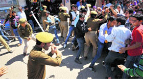 Policemen cane-charge activists of J&K National Youth Corps in Jammu on Monday.