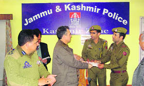 IGP, Kashmir, AG Mir distributes prizes among the winners of the debating competition.