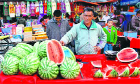 A vendor sells watermelon in Srinagar on Monday.