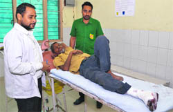 Ram Aasra, whose leg came under a tyre of a moving bus, recuperates at the Civil Hospital; and (below) policemen question the driver (second from left) at the accident spot near the railway station in Ludhiana on Monday.