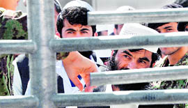 Detainees wait to be released from the Bagram prison in Afghanistan on Monday.