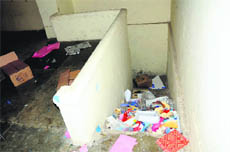 A littered staircase that leads to the green-rooms of an auditorium in Government Rajindra College.