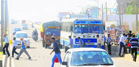 Passengers cross the flyover after alighting from a bus in Zirakpur.