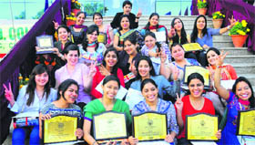 students of GGDSD College, Sector 32, show their awards after the annual prize distribution ceremony in Chandigarh on Tuesday.