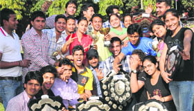 Students in a jubilant mood after receiving trophies during the annual prize distribution function at the PU.